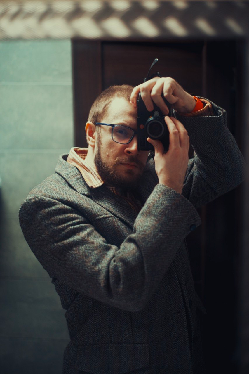 Serhii Diedushev holding a camera