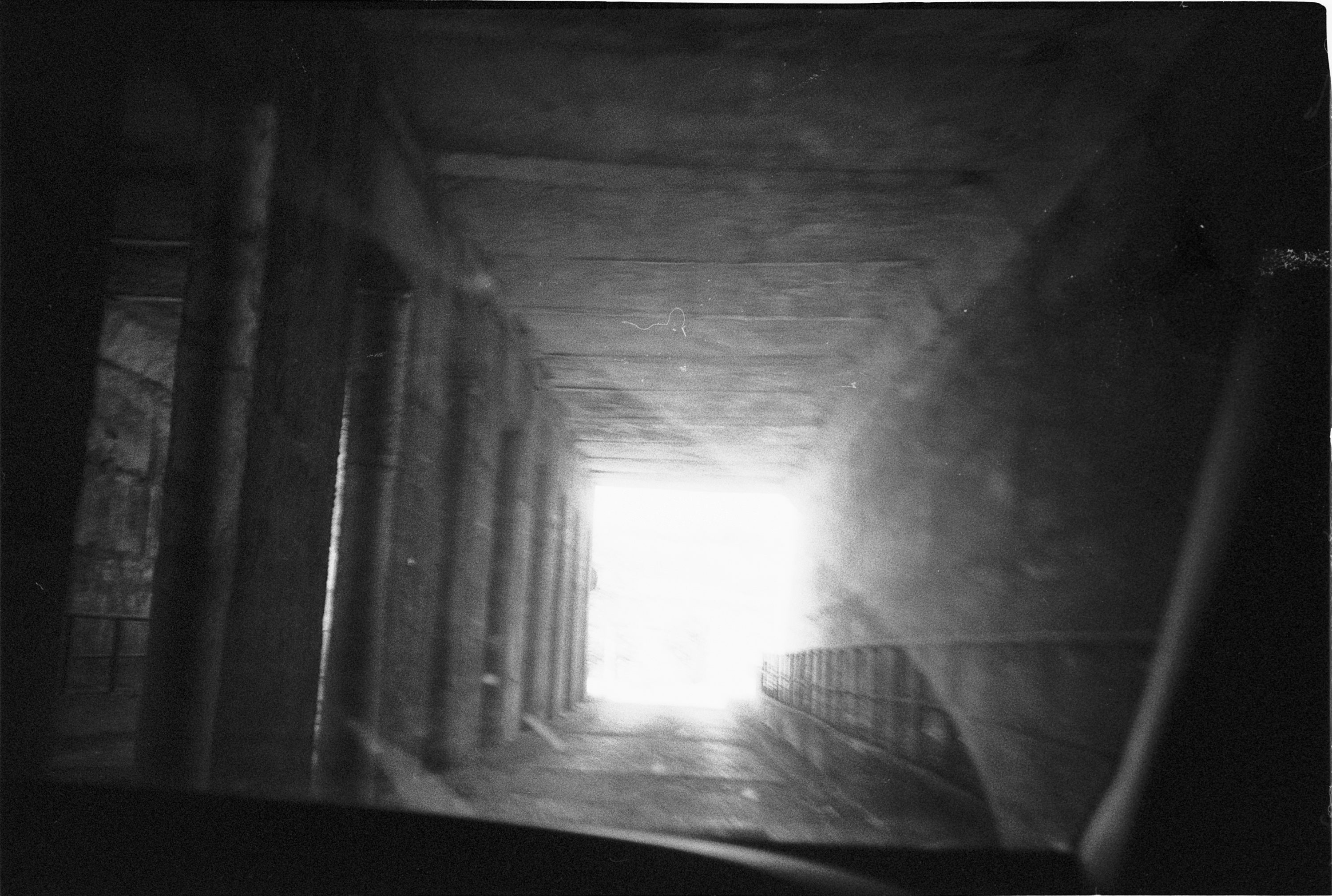 Blurred corridor ending in bright light
