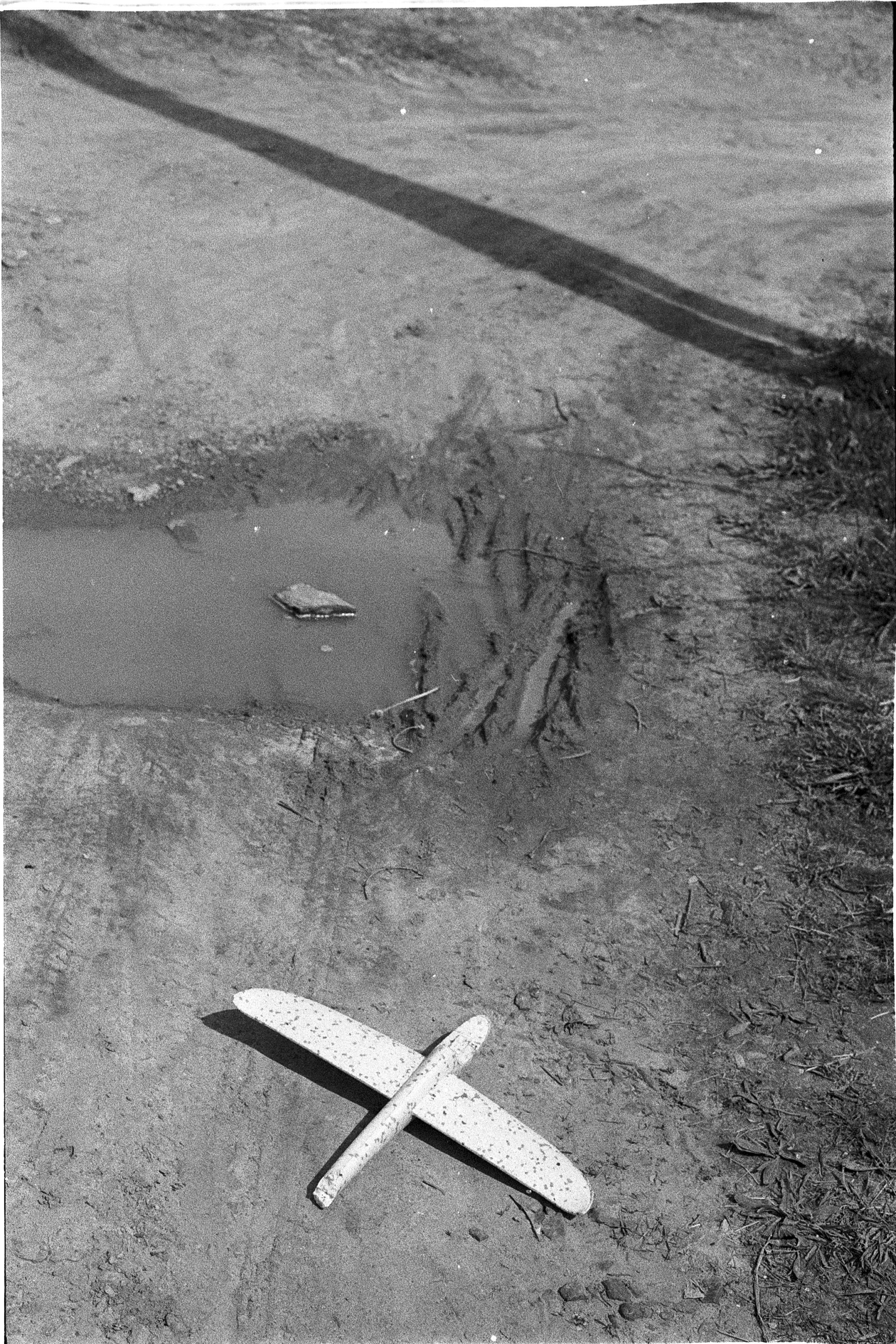 A broken toy airplane on the ground