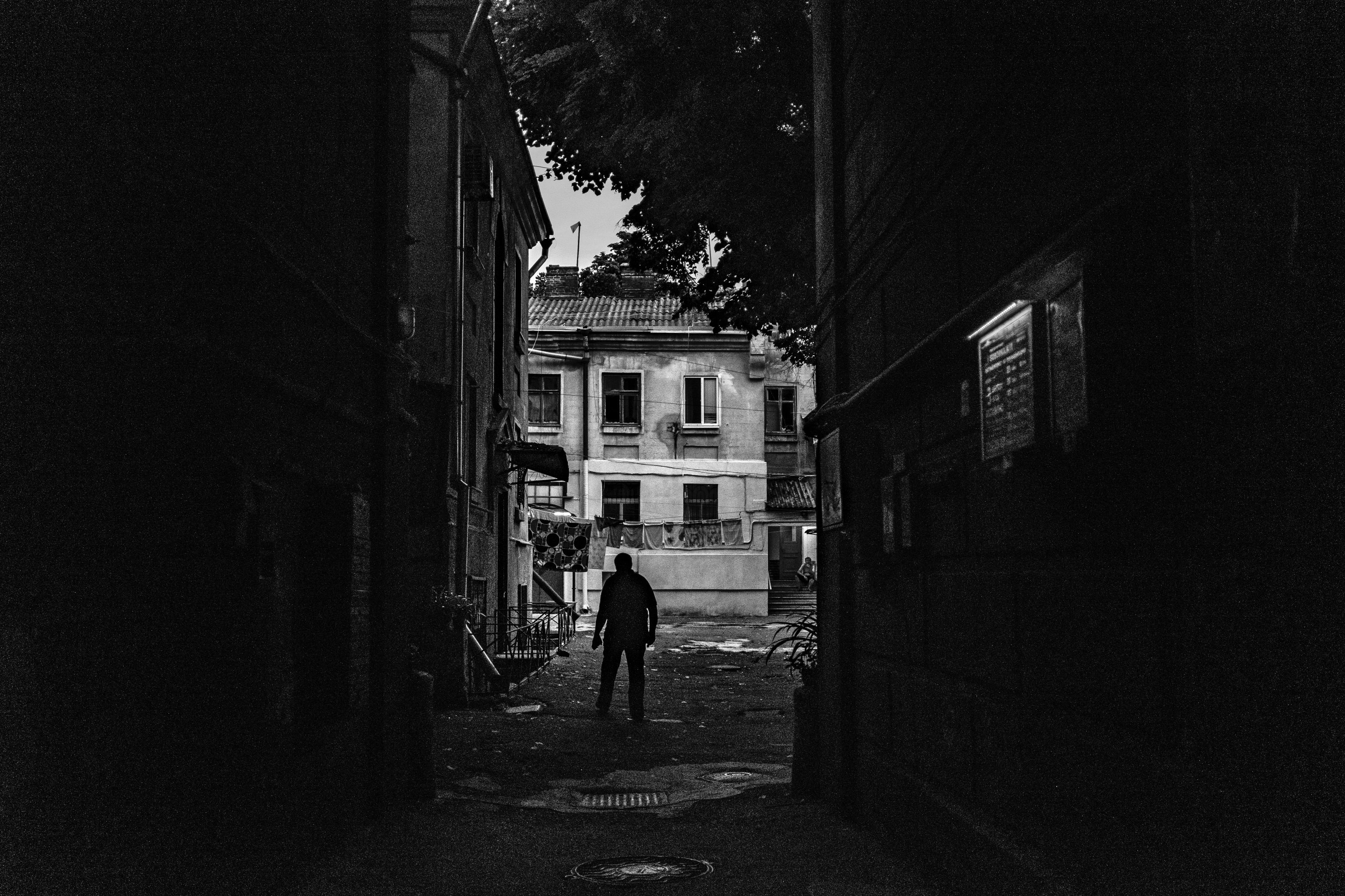 A silhouette standing in a dark passage