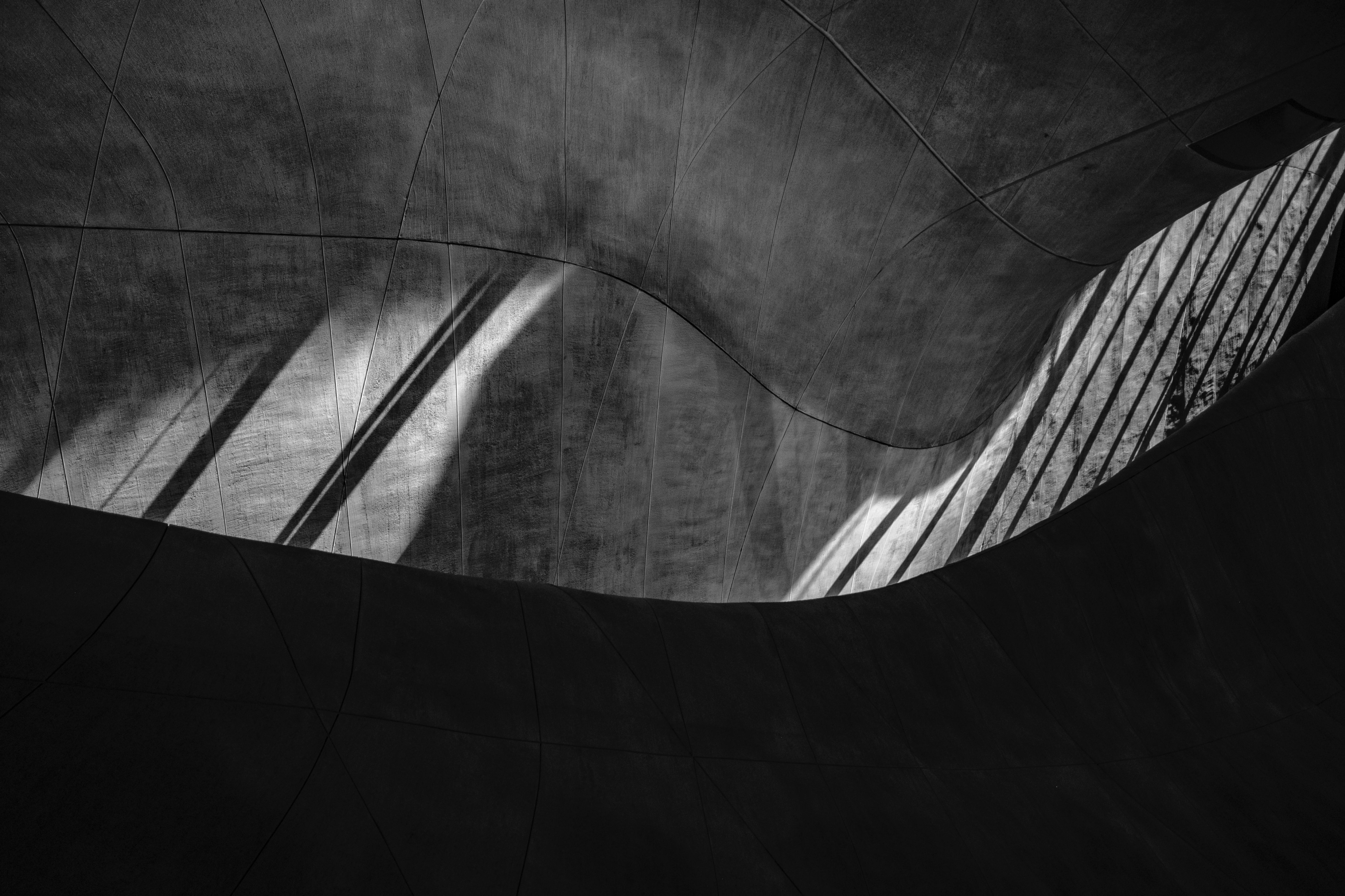 Architectural shadows on a curved wall